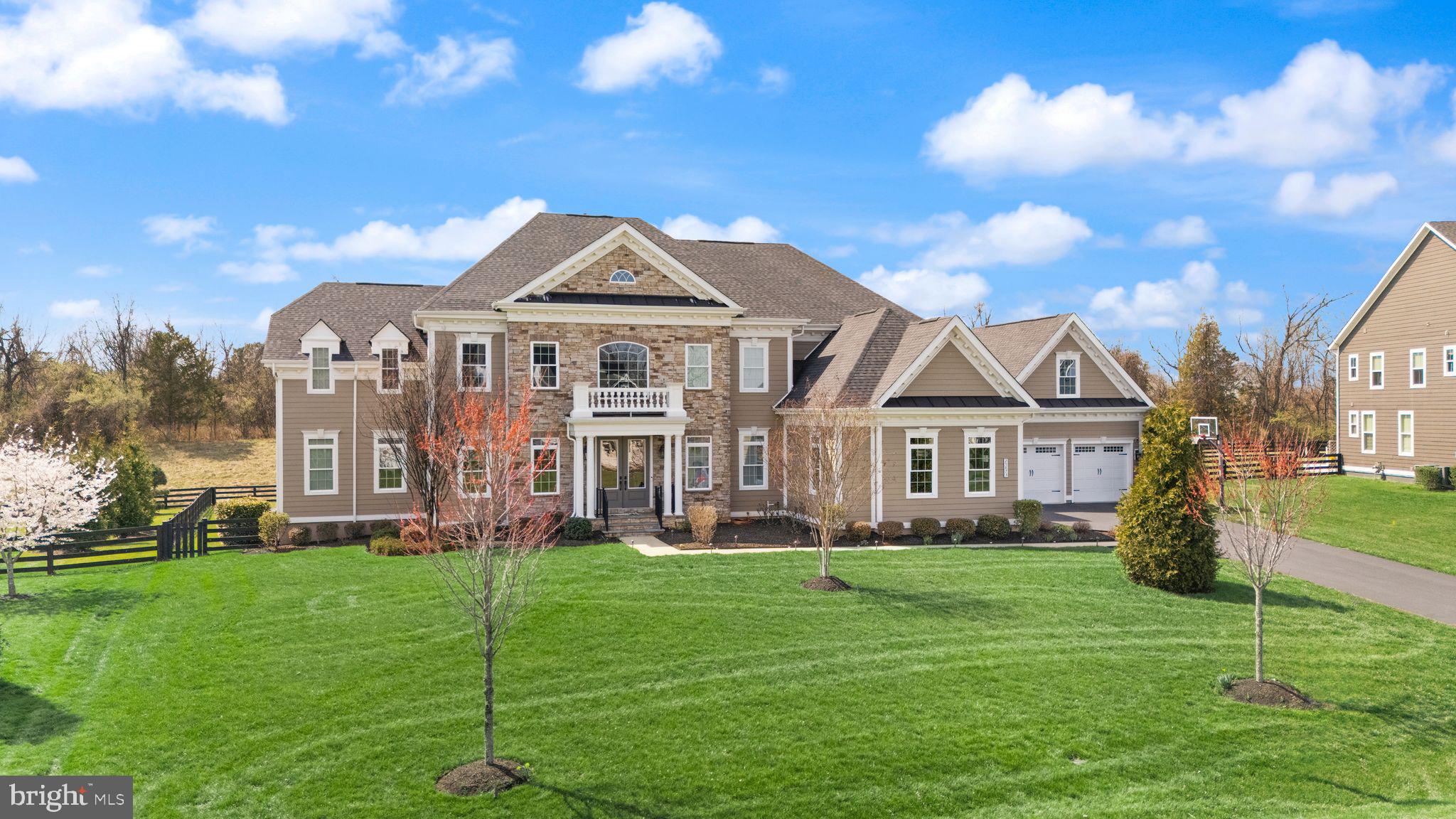 25873 Cameron Walk Place Aldie, VA 20105 - Photo 2 of 92 a front view of a house with a garden