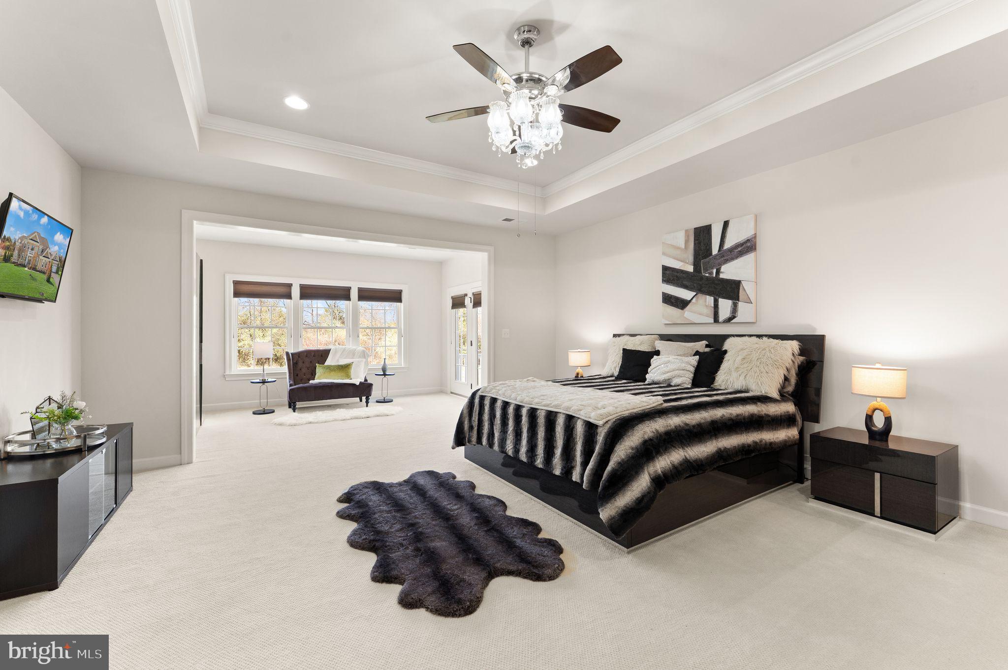25873 Cameron Walk Place Aldie, VA 20105 - Photo 23 of 92 a spacious bedroom with a bed and a chandelier
