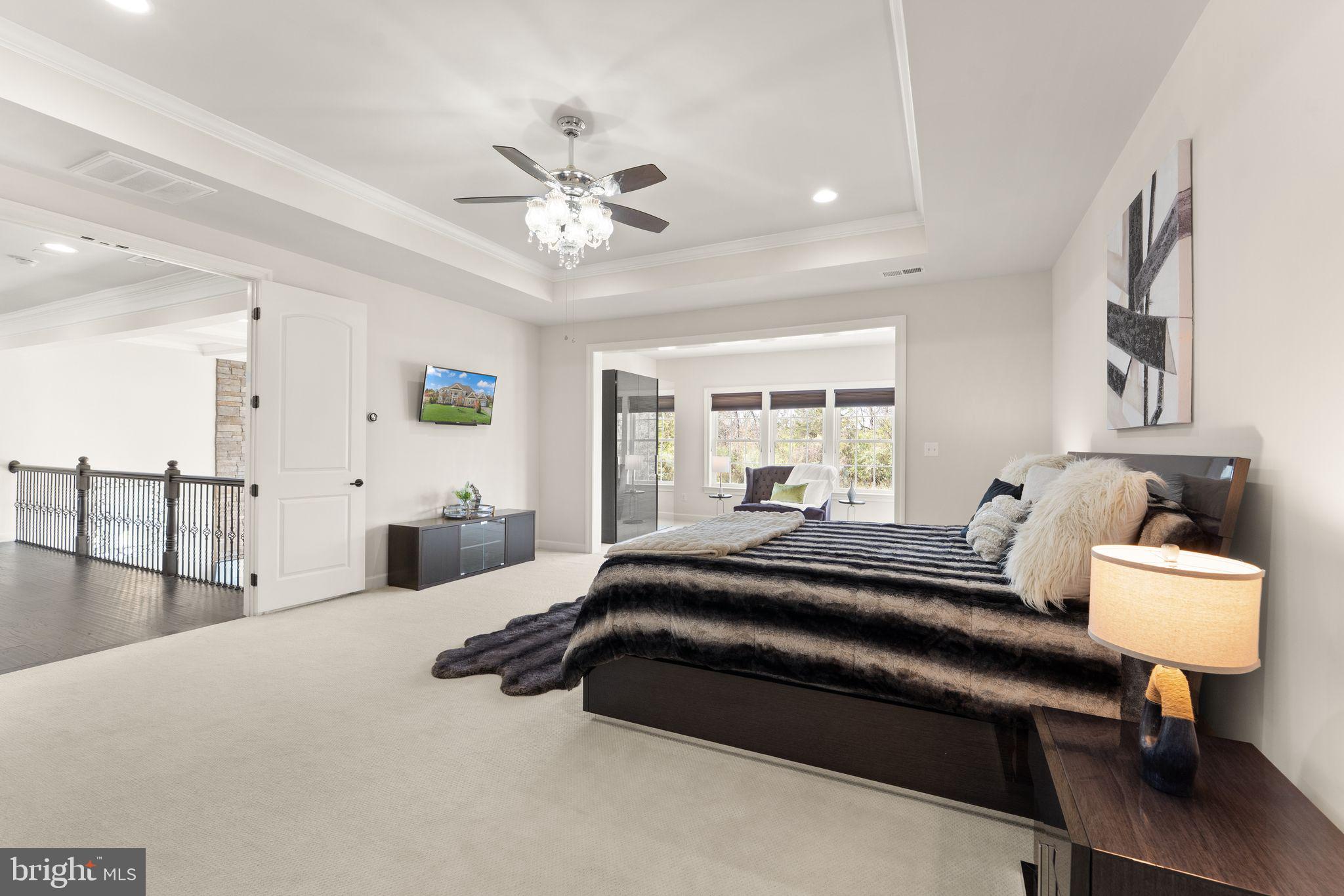 25873 Cameron Walk Place Aldie, VA 20105 - Photo 24 of 92 a bedroom with a bed and a chandelier