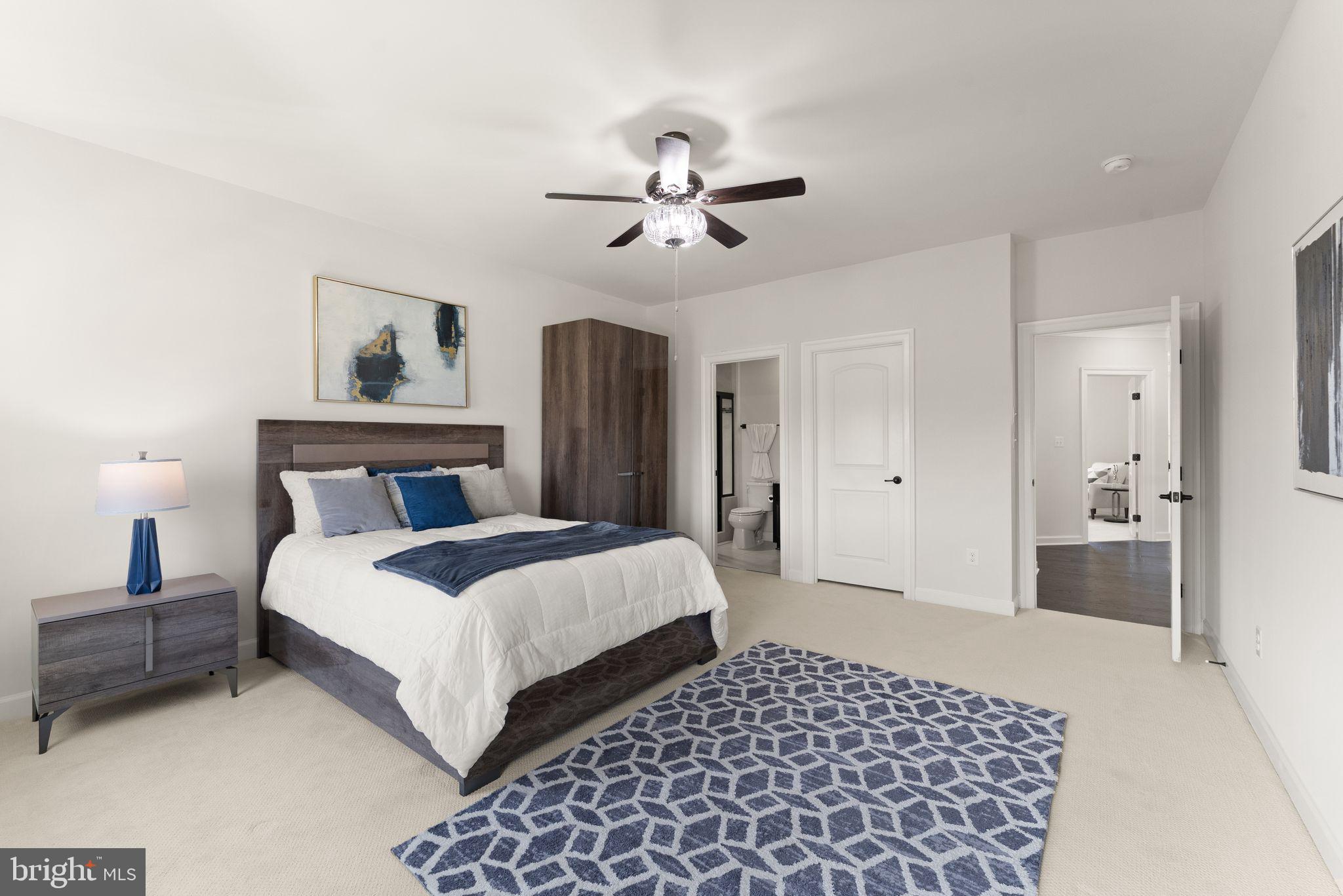 25873 Cameron Walk Place Aldie, VA 20105 - Photo 30 of 92 a bedroom with a bed and a chandelier