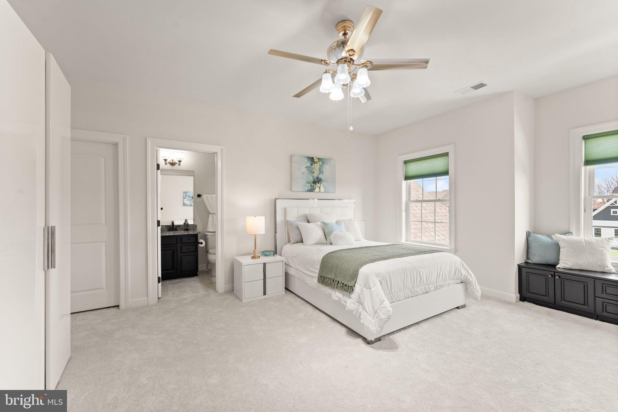 25873 Cameron Walk Place Aldie, VA 20105 - Photo 32 of 92 a spacious bedroom with a bed and a chandelier