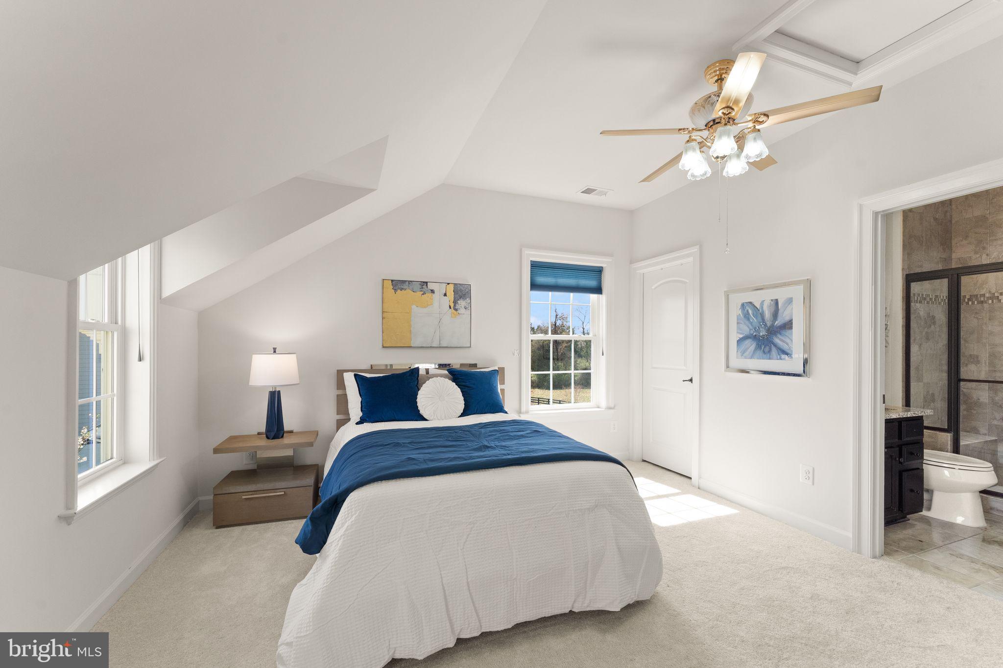 25873 Cameron Walk Place Aldie, VA 20105 - Photo 38 of 92 a bedroom with a large bed and a chandelier