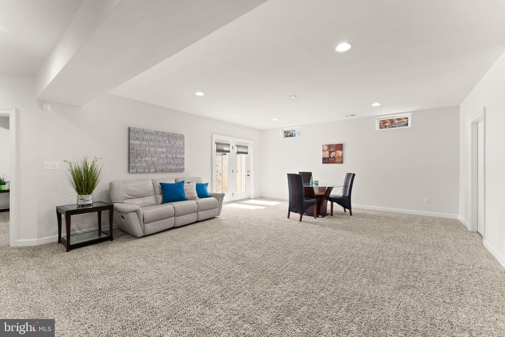 25873 Cameron Walk Place Aldie, VA 20105 - Photo 40 of 92 a living room with furniture and a chandelier