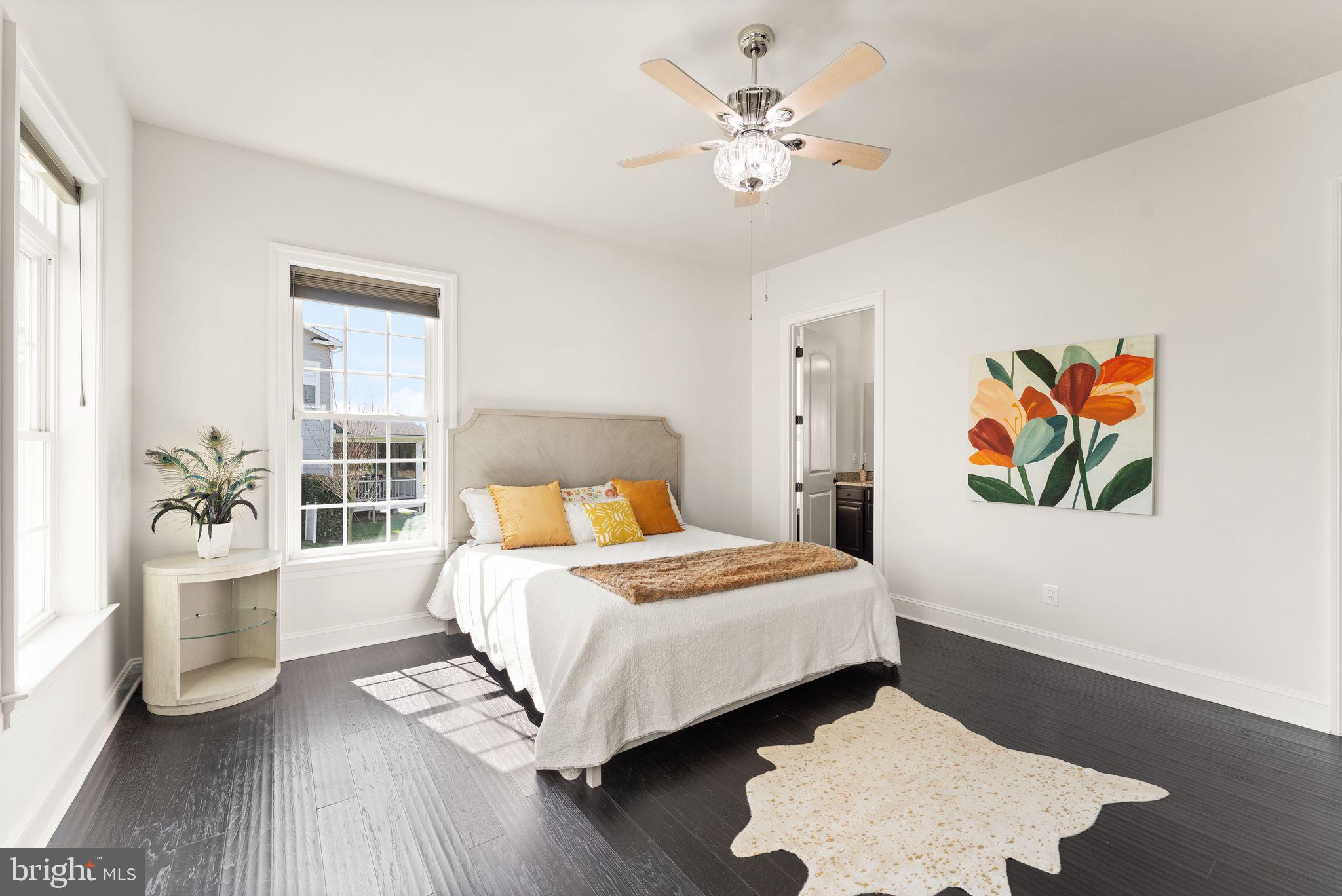 25873 Cameron Walk Place Aldie, VA 20105 - Photo 50 of 92 a bedroom with a bed and a chandelier