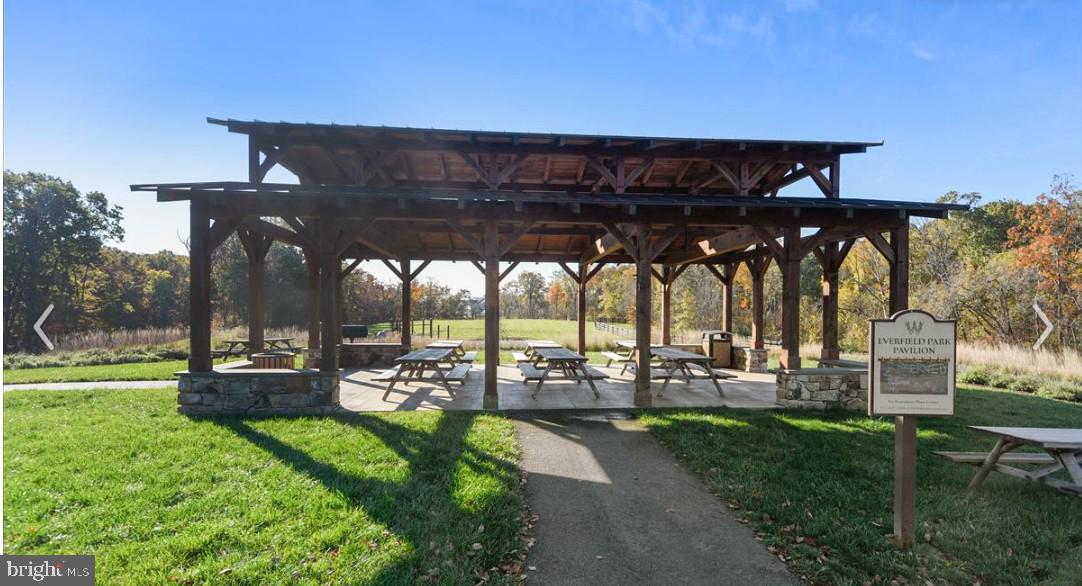 25873 Cameron Walk Place Aldie, VA 20105 - Photo 64 of 92 a view of a chairs and table in patio with a yard