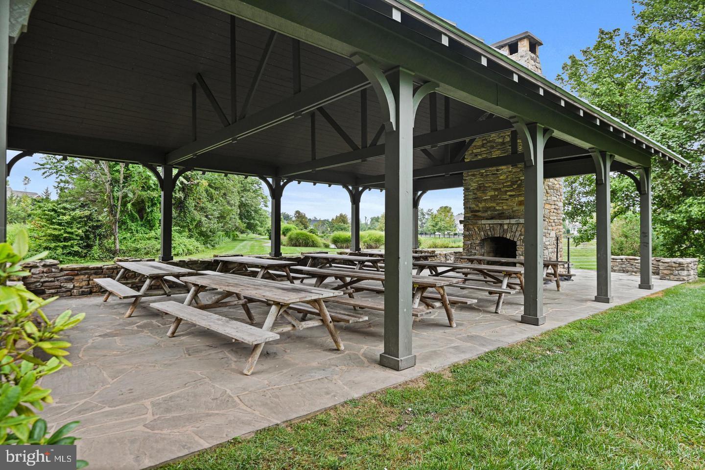 25873 Cameron Walk Place Aldie, VA 20105 - Photo 76 of 92 a view of a patio with table and chairs under an umbrella