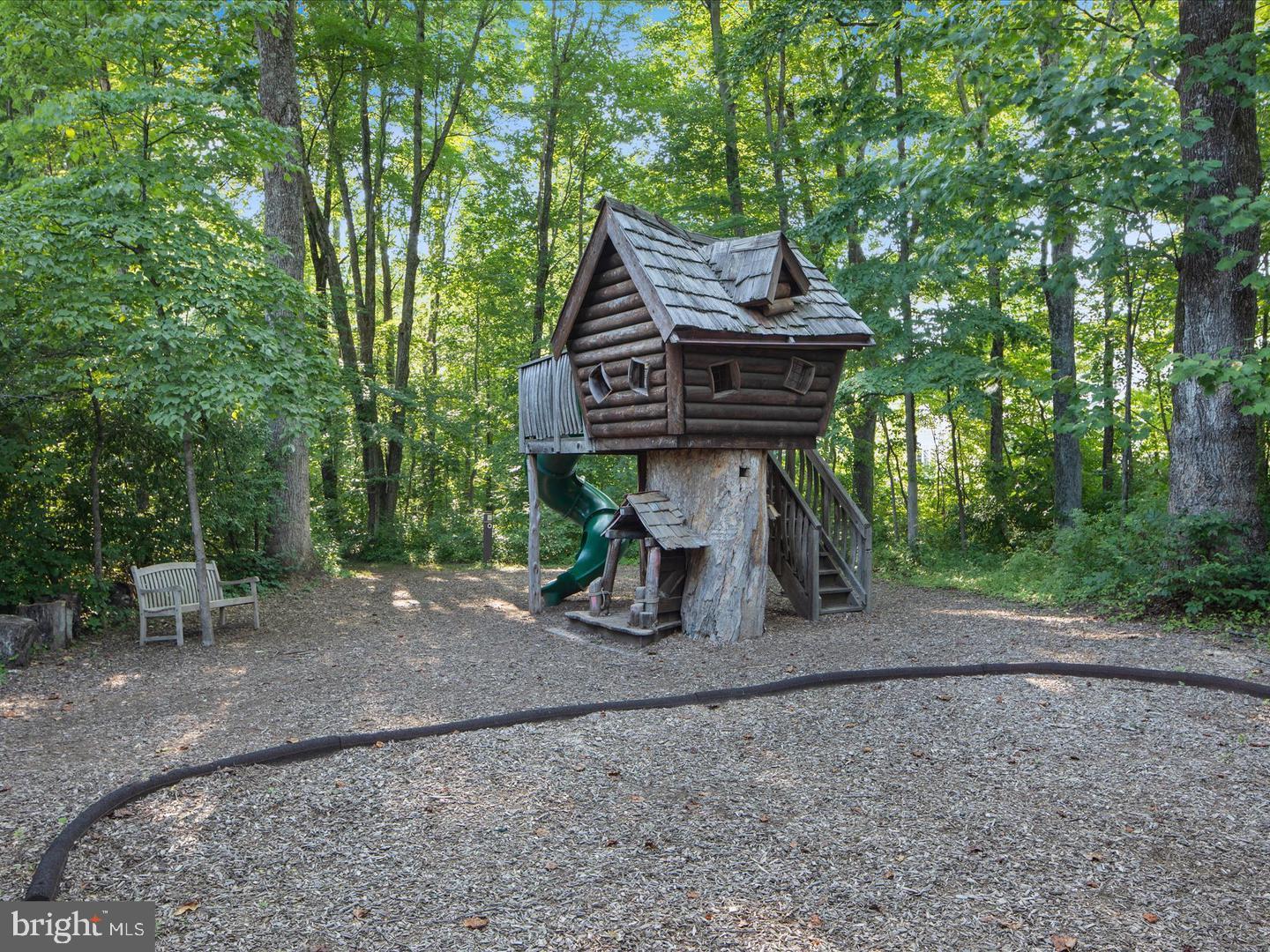 25873 Cameron Walk Place Aldie, VA 20105 - Photo 82 of 92 a view of a wooden chairs and table in the backyard