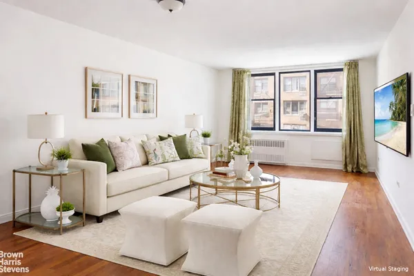 a living room with furniture and floor to ceiling windows