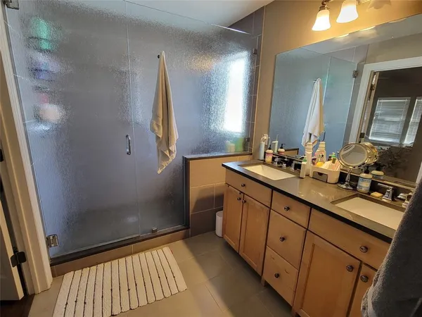 a bathroom with a double vanity sink and mirror