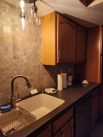 a kitchen with a sink and cabinets