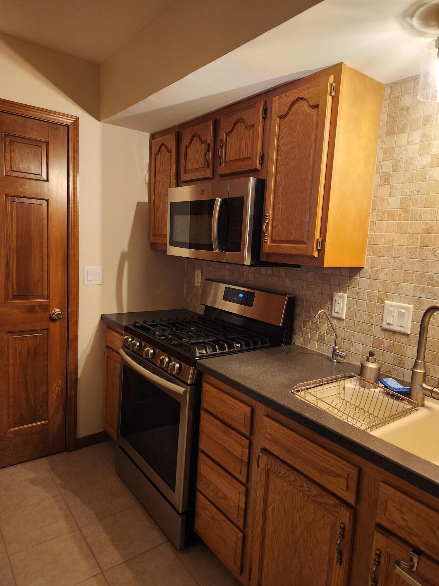 1920 David Drive Chesterton, IN 46304 - Photo 12 of 21 a kitchen with stainless steel appliances granite countertop a sink stove and microwave