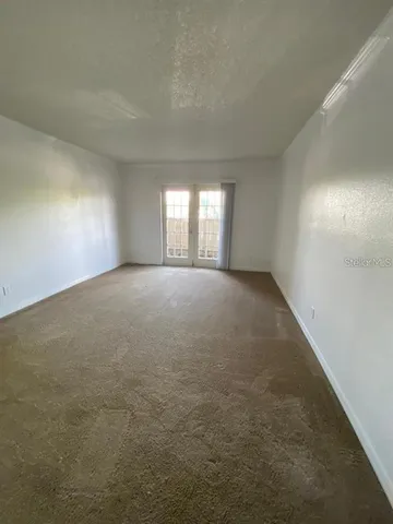 a view of an empty room and a window