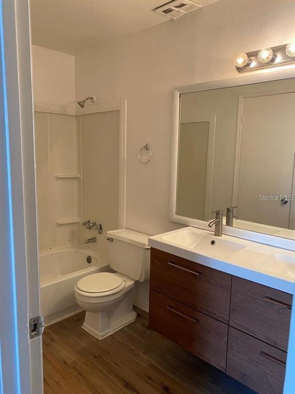 285 Wymore Road, Unit 101 Altamonte Springs, FL 32714 - Photo 8 of 9 a bathroom with a double vanity sink and mirror with toilet