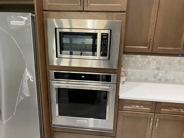 a kitchen with a stove and a refrigerator