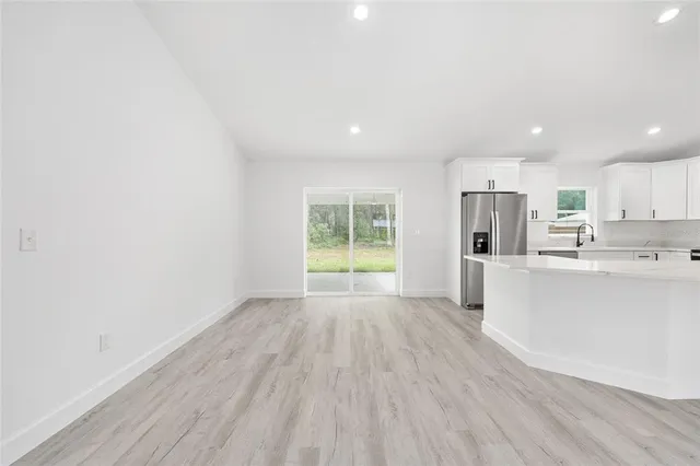 a view of kitchen with wooden floor and electronic appliances