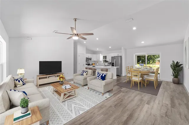 a living room with furniture a table and a flat screen tv