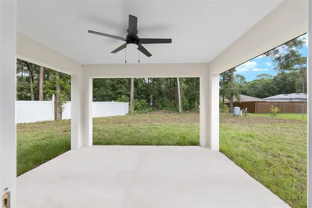 a view of a porch with a floor to ceiling windows and yard