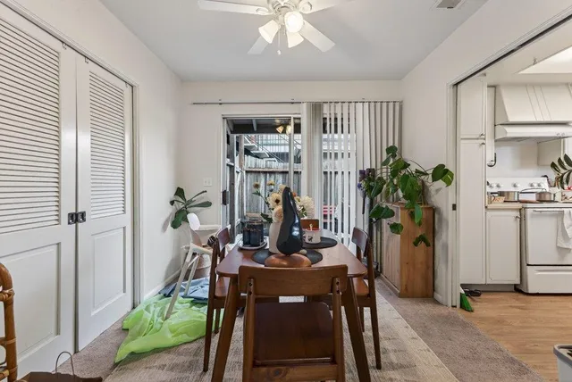 a view of a dining room with furniture and a window