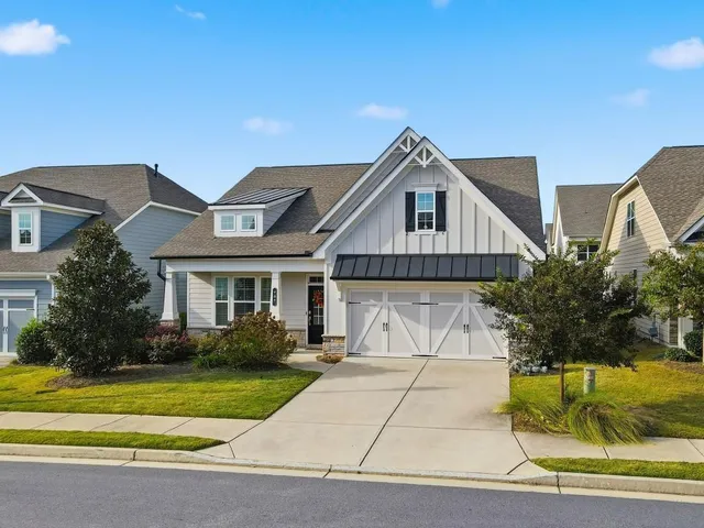 a front view of a house with a garden and plants