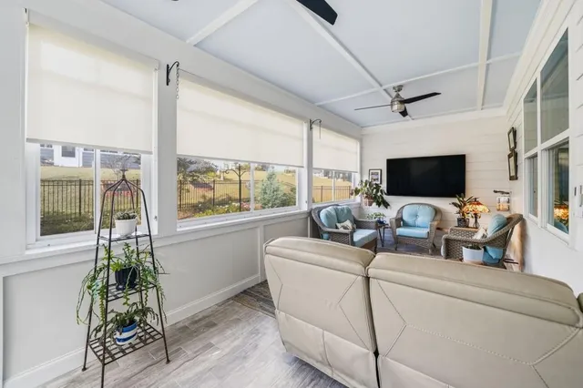 a living room with lots of furniture and wooden floor