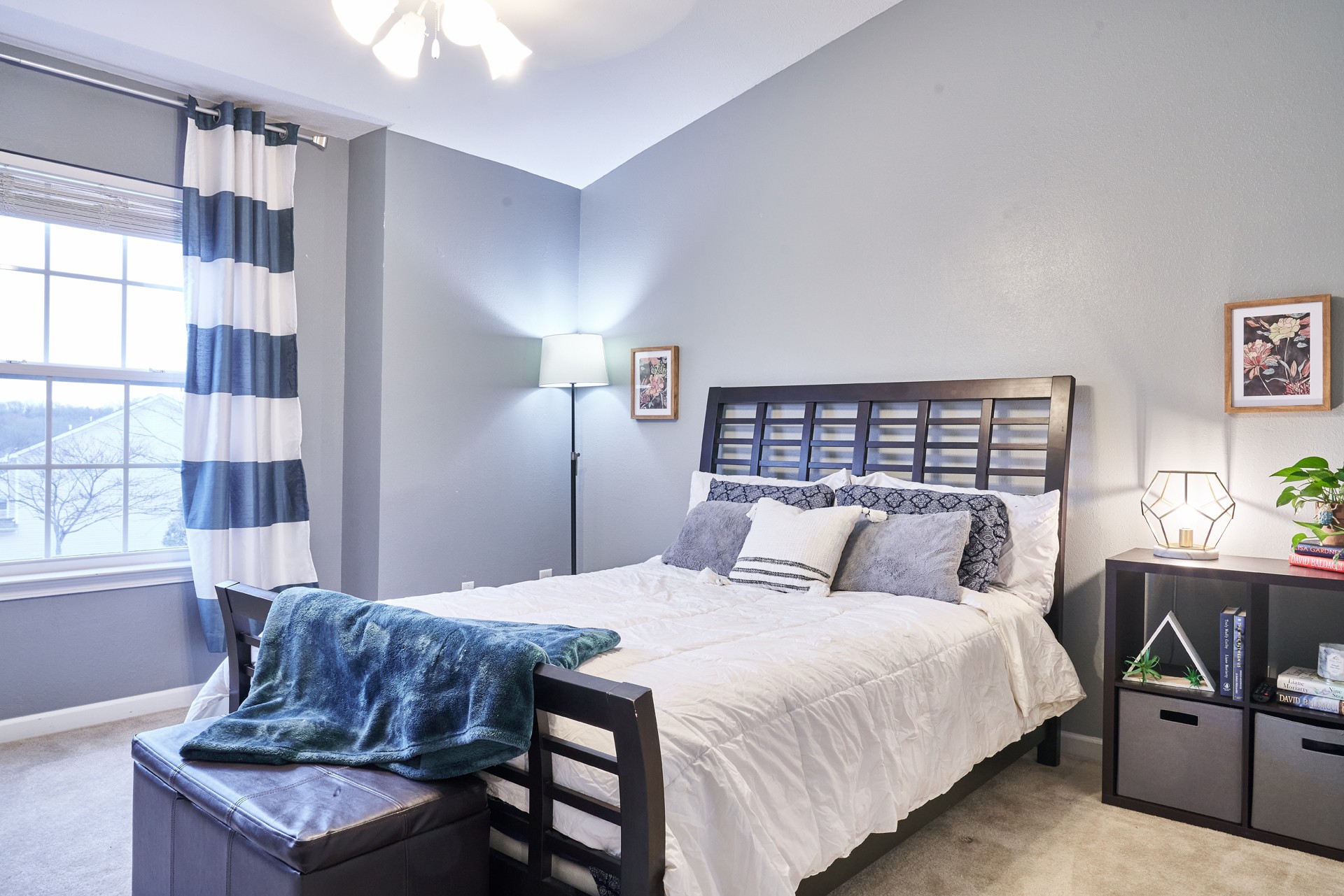 1924 Shaylin Loop Antioch, TN 37013 - Photo 19 of 22 a bedroom with a bed a bookshelf and a couch