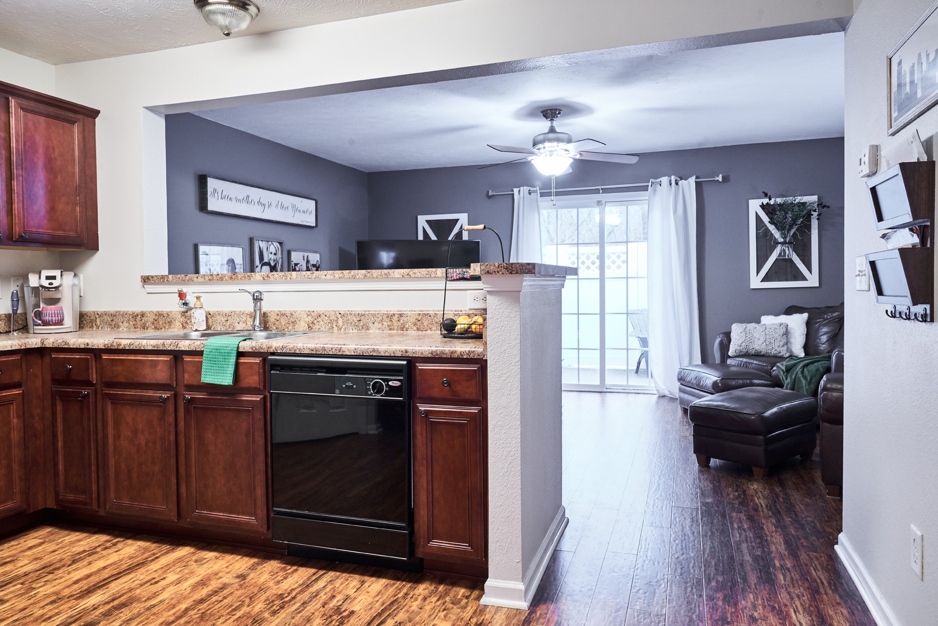 1924 Shaylin Loop Antioch, TN 37013 - Photo 8 of 22 a kitchen with kitchen island granite countertop wooden floors and stainless steel appliances