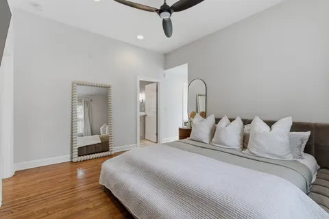 a bedroom with a bed and wooden floor