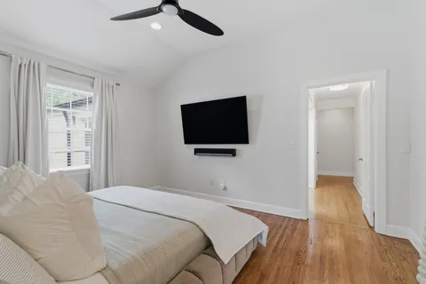 a bedroom with a bed and a flat screen tv