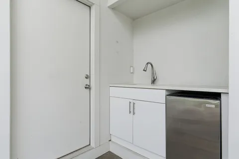 a close view of a closet a mirror and cabinets