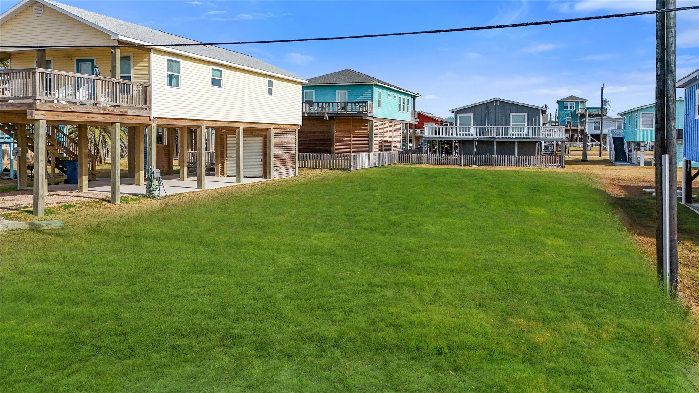 0 Ocean Avenue Surfside Beach, TX 77541 - Photo 4 of 19 a view of a big house with a big yard and large trees