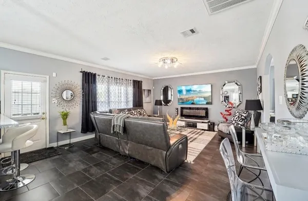 a living room with fireplace furniture and a window