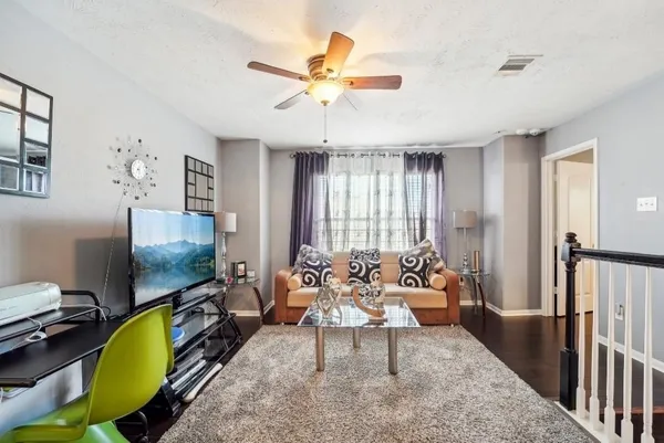 a living room with furniture and a chandelier