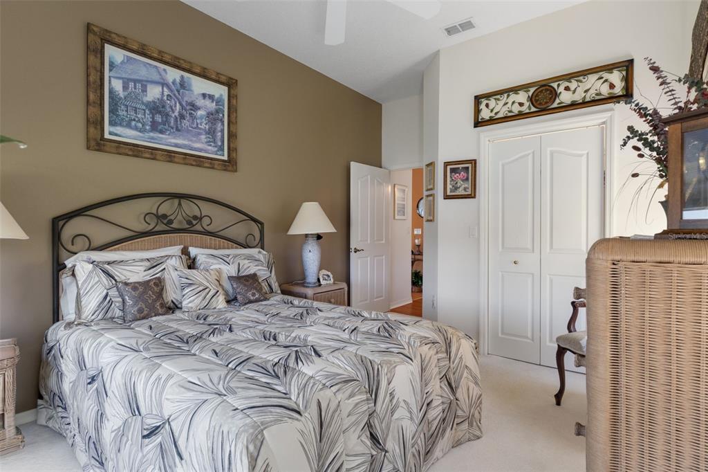 10081 Georgetown Court Weeki Wachee, FL 34613 - Photo 44 of 76 a bedroom with a bed and a painting on the wall