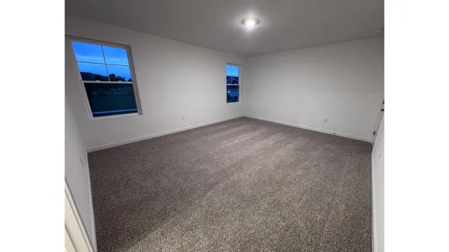 a view of an empty room with wooden floor and air conditioner