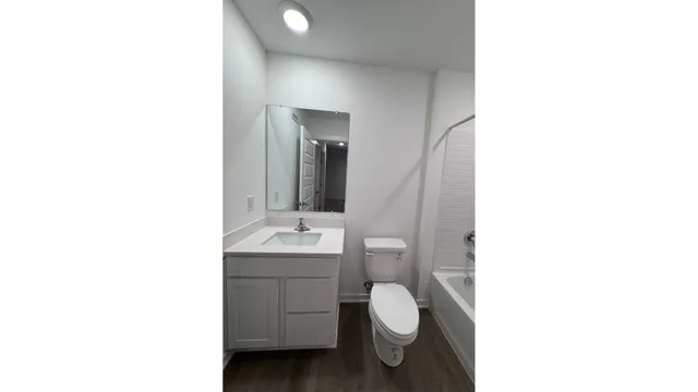a bathroom with a toilet and a shower
