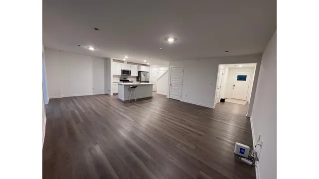 a view of a kitchen with wooden floor and a sink