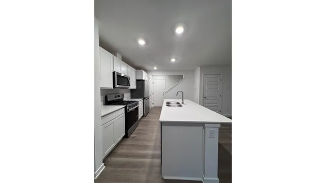 a kitchen with a sink and stainless steel appliances