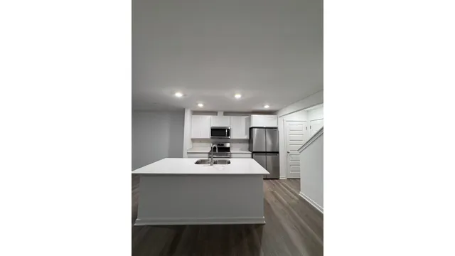 a kitchen with a sink cabinets and a window