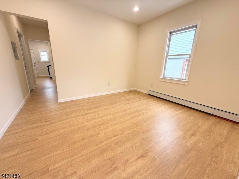 356 Carnegie Place, Unit 1 Union, NJ 07088 - Photo 1 of 10 a view of an empty room with wooden floor and a window
