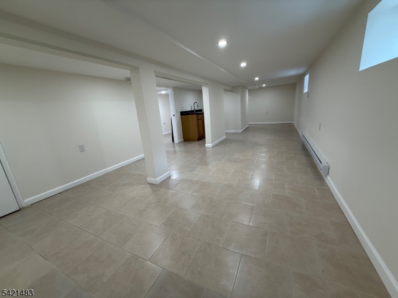 356 Carnegie Place, Unit 1 Union, NJ 07088 - Photo 8 of 10 a view of a big room with a fireplace and cabinet