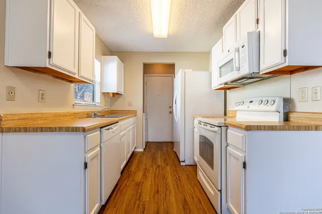 a kitchen with a sink and cabinets