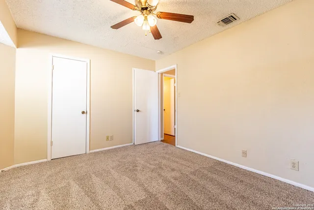 a view of an empty room with a cabinet