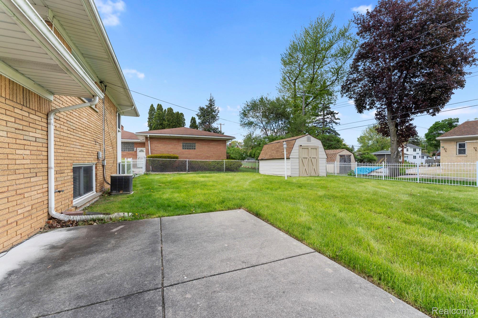 23410 Joy Road Redford, MI 48239 - Photo 22 of 25 Fenced backyard featuring a storage shed