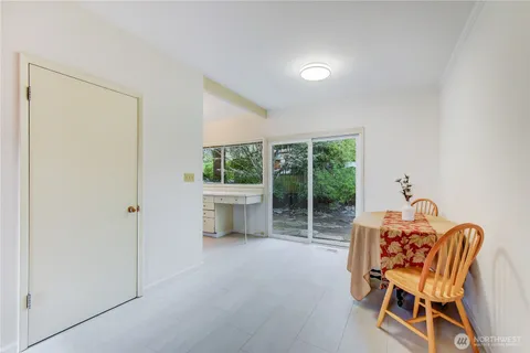 a dining room with furniture and a window
