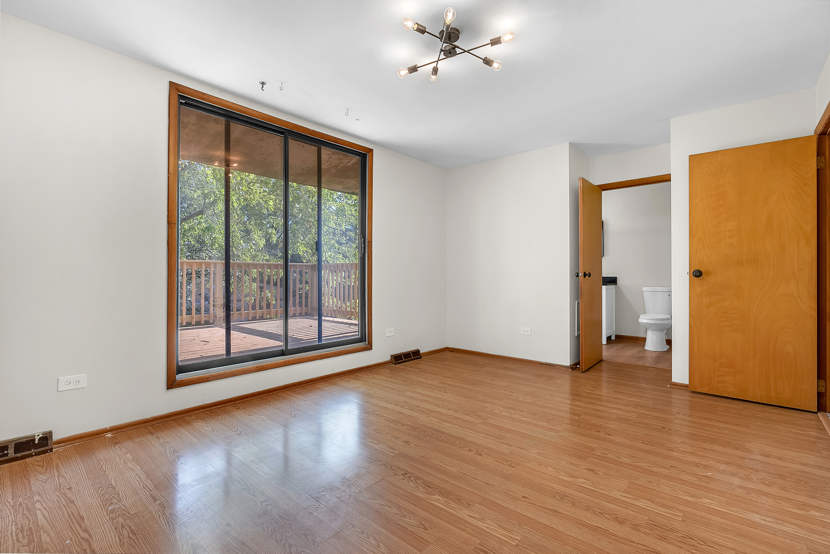 2957 192nd Place Lansing, IL 60438 - Photo 12 of 25 an empty room with wooden floor and windows