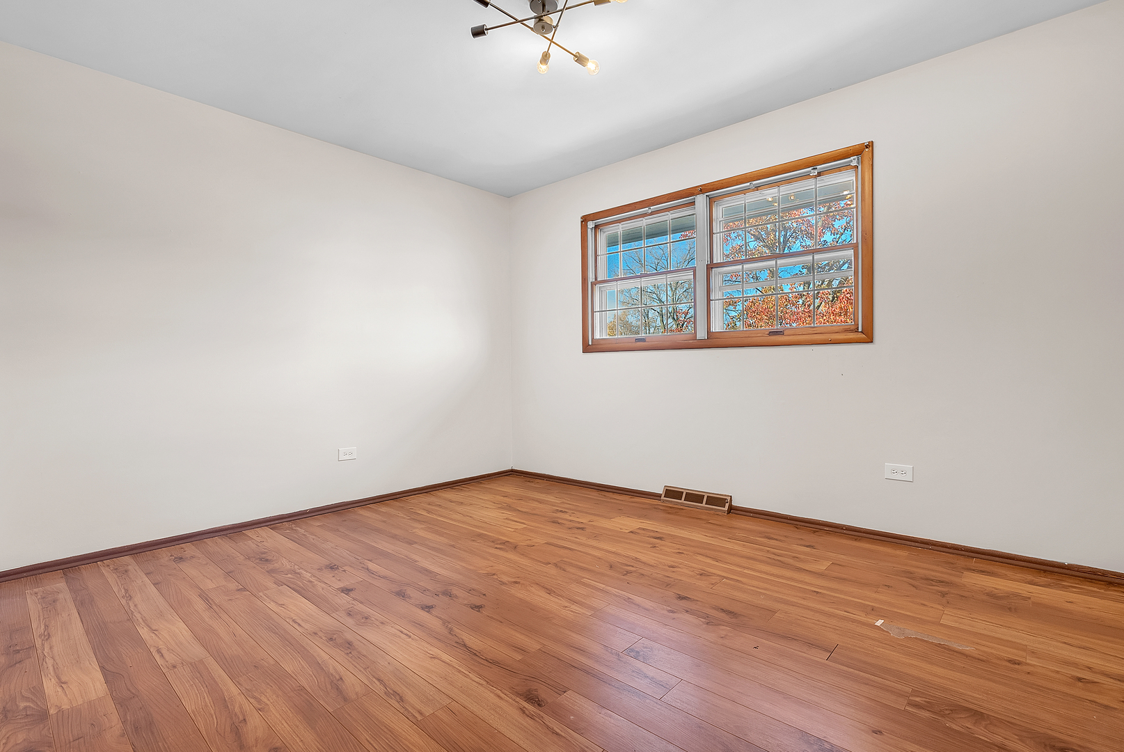 2957 192nd Place Lansing, IL 60438 - Photo 16 of 25 a view of an empty room with a window and wooden floor