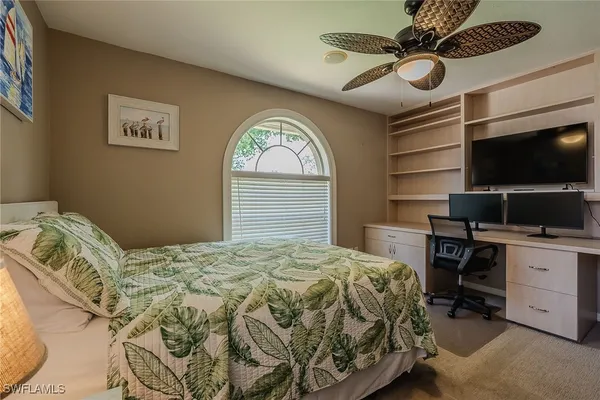 a bedroom with a bed and a television