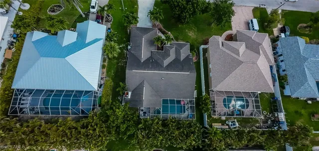 an aerial view of multiple houses with a yard