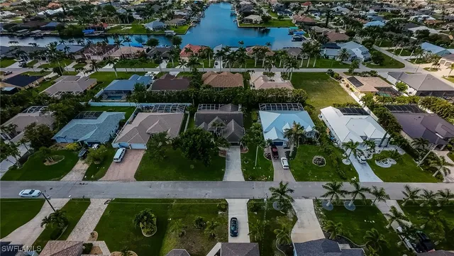 an aerial view of residential houses with outdoor space and street view