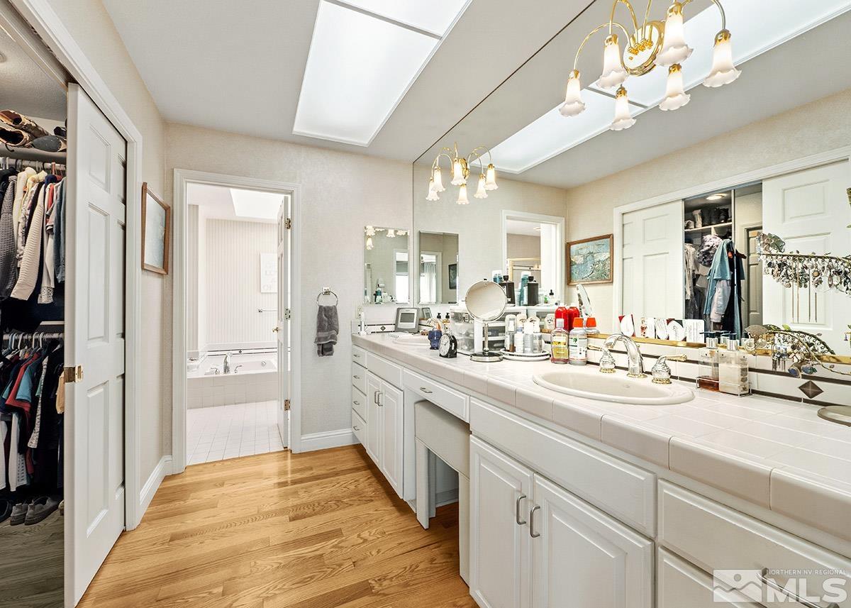 2215 Hedgewood Drive Reno, NV 89509 - Photo 24 of 39 a large white kitchen with a large window a sink and stainless steel appliances